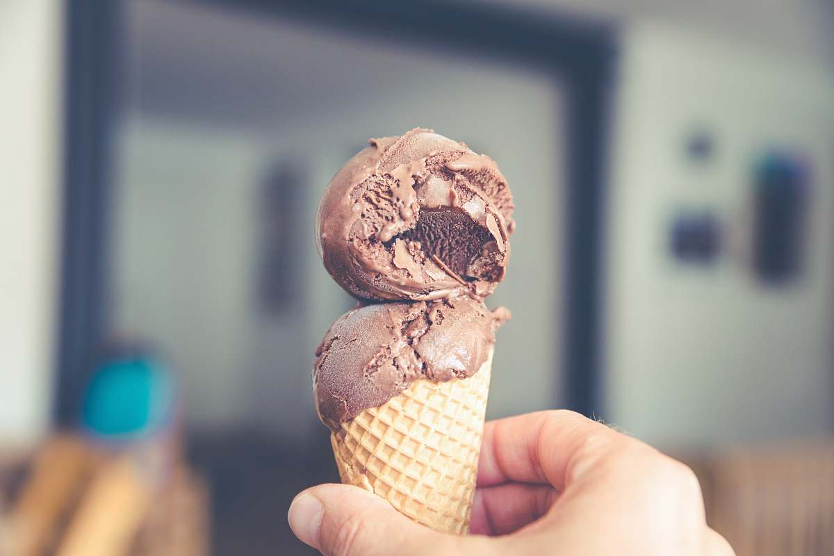 ice cream selective focus photography of chocolate ice cream on brown cone cream